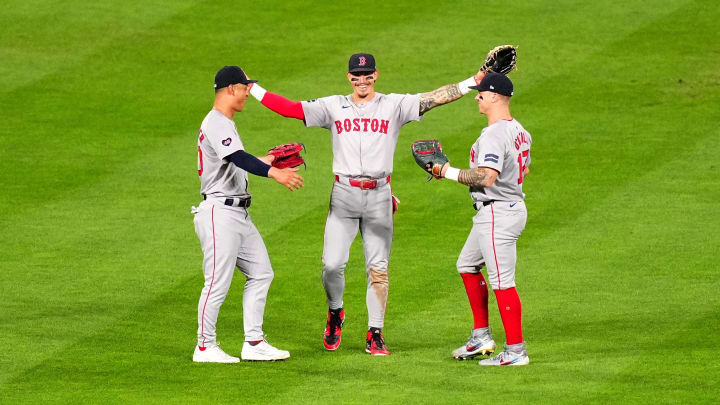 Jul 23, 2024; Denver, Colorado, USA; Boston Red Sox left fielder Rob Refsnyder (30) and Boston Red Sox center fielder Jarren Duran (16) and right fielder Tyler O'Neill (17) celebrate defeating the Colorado Rockies at Coors Field. Mandatory Credit: Ron Chenoy-USA TODAY Sports