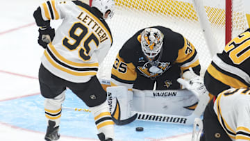 Tristan Jarry (35) makes a save against Boston Bruins center Vinni Lettieri (95) during the second period at PPG Paints Arena. Mandatory Credit: Charles LeClaire-Imagn Images