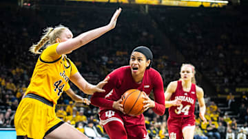 Indiana forward Kiandra Browne, center, drives to the basket against Iowa's Addison O'Grady during a NCAA Big Ten Conference women's basketball game, Monday, Feb. 21, 2022, at Carver-Hawkeye Arena in Iowa City, Iowa.