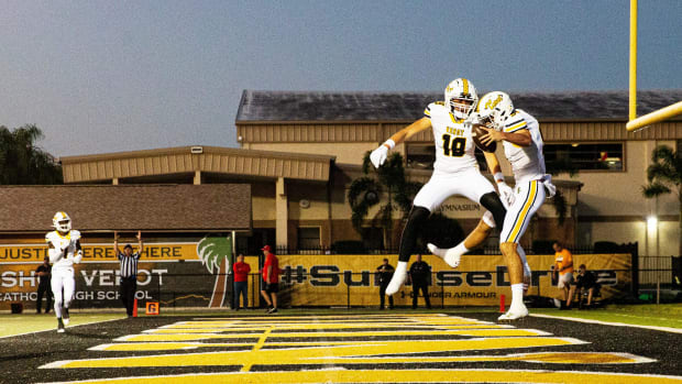 Carter Smith, right, the quarterback for Bishop Verot, is congratulated by teammate, Leo Berman after a touchdown