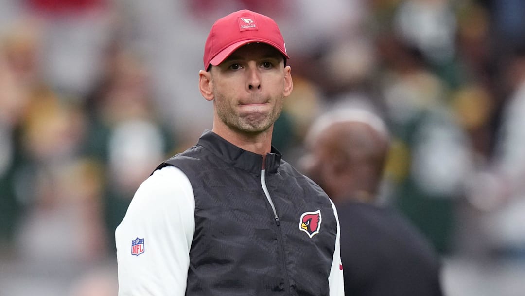 Arizona Cardinals head coach Jonathan Gannon watches as his team warms up before playing against the Green Bay Packers at State Farm Stadium in Glendale on Oct. 19, 2025. Arizona Cardinals head coach Jonathan Gannon watches as his team warms up before playing against the Green Bay Packers at State Farm Stadium in Glendale on Oct. 19, 2025.