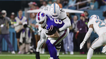 Jan 7, 2024; Miami Gardens, Florida, USA; Buffalo Bills tight end Dalton Kincaid (86) is tackled by Miami Dolphins linebacker Jerome Baker (55) after running with the football during the second quarter at Hard Rock Stadium. Mandatory Credit: Sam Navarro-Imagn Images