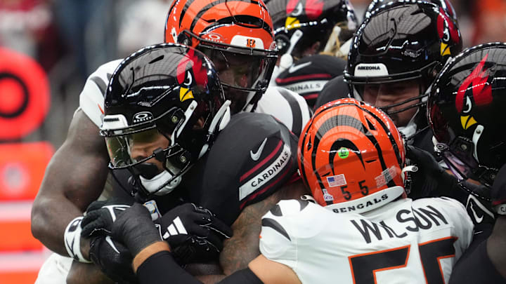 Arizona Cardinals running back James Conner (6) is wrapped up by Cincinnati Bengals linebacker Logan Wilson (55) at State Farm Stadium in Glendale on Oct. 8, 2023.