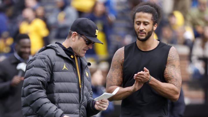 Apr 2, 2022; Ann Arbor, Michigan, USA;  Michigan Wolverines head coach Jim Harbaugh talks to Colin Kaepernick during halftime at the Michigan Spring game at Michigan Stadium. Mandatory Credit: Rick Osentoski-USA TODAY Sports