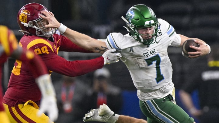 Jan 2, 2023; Arlington, Texas, USA; Tulane Green Wave quarterback Michael Pratt (7) stiff arms USC Trojans defensive lineman Nick Figueroa (99) as Figueroa attempts to make the tackle during the second half in the 2023 Cotton Bowl at AT&T Stadium. Mandatory Credit: Jerome Miron-USA TODAY Sports