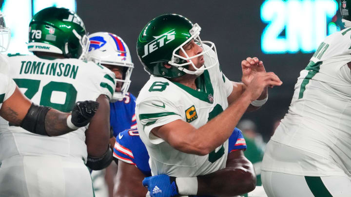 Sep 11, 2023; East Rutherford, NJ; New York Jets quarterback Aaron Rodgers (8) is taken down after the throw by Buffalo Bills defensive end Greg Rousseau (50) during the first half at MetLife Stadium. 