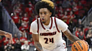 Dec 3, 2024; Louisville, Kentucky, USA;  Louisville Cardinals guard Chucky Hepburn (24) dribbles against Mississippi Rebels forward Jaemyn Brakefield (4) during the second half at KFC Yum! Center.