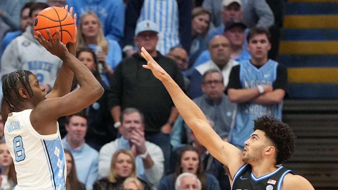 Feb 7, 2026; Chapel Hill, North Carolina, USA;  North Carolina Tar Heels forward Caleb Wilson (8) shoots as Duke Blue Devils forward Cameron Boozer (12) defends in the first  half at Dean E. Smith Center. Mandatory Credit: Bob Donnan-Imagn Images