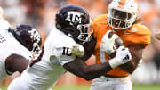 Tennessee running back Jaylen Wright (0) is grabbed by Texas A&M defensive lineman Fadil Diggs