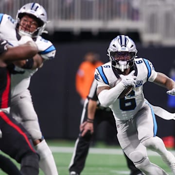 Carolina Panthers running back Miles Sanders runs the ball against the Atlanta Falcons in the third quarter at Mercedes-Benz Stadium.