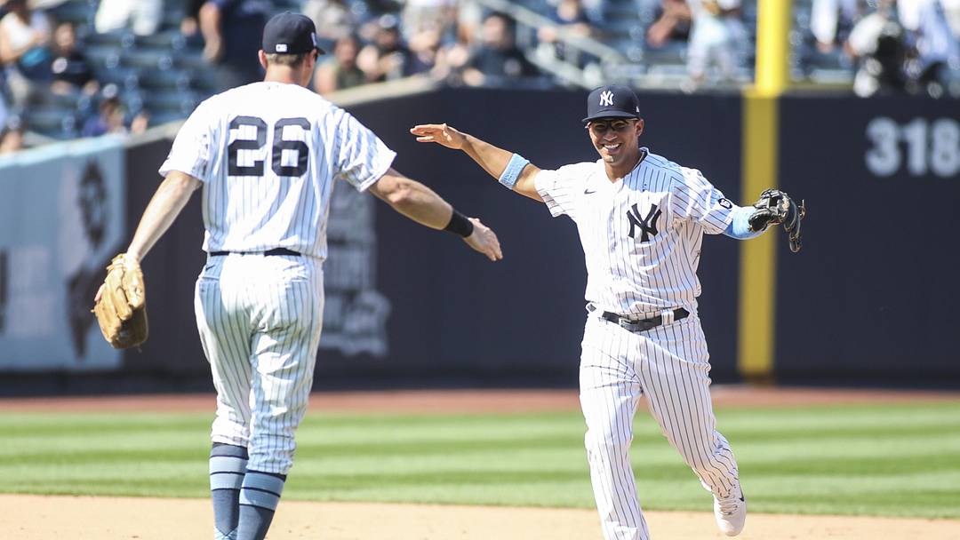 Jun 20, 2021; Bronx, New York, USA; New York Yankees shortstop Gleyber Torres (25) celebrates with second baseman DJ LeMahieu (26) after turning a triple play to defeat the Oakland Athletics 2-1 at Yankee Stadium. Mandatory Credit: Wendell Cruz-Imagn Images