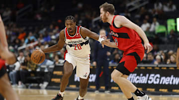 Oct 11, 2024; Washington, District of Columbia, USA; Washington Wizards forward Alex Sarr (20) drives to the basket as Toronto Raptors center Jakob Poeltl (19) in the second quarter at Capital One Arena. Mandatory Credit: Geoff Burke-Imagn Images