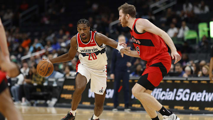 Oct 11, 2024; Washington, District of Columbia, USA; Washington Wizards forward Alex Sarr (20) drives to the basket as Toronto Raptors center Jakob Poeltl (19) in the second quarter at Capital One Arena. Mandatory Credit: Geoff Burke-Imagn Images
