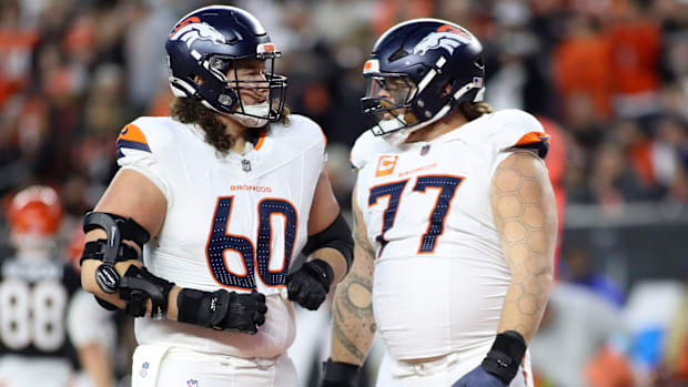 Denver Broncos linemen Luke Wattenberg (60) and Quinn Meinerz (77) talk vs. the Cincinnati Bengals.