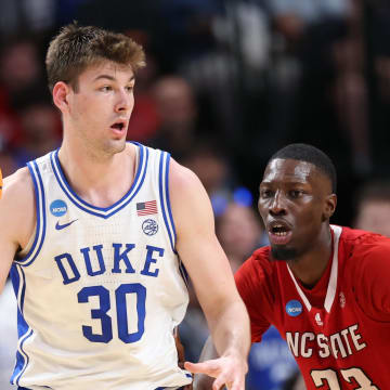 Mar 31, 2024; Dallas, TX, USA; Duke Blue Devils center Kyle Filipowski (30) controls the ball against North Carolina State Wolfpack forward Mohamed Diarra (23) in the second half in the finals of the South Regional of the 2024 NCAA Tournament at American Airline Center. Mandatory Credit: Kevin Jairaj-USA TODAY Sports