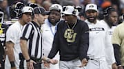 Dec 28, 2024; San Antonio, TX, USA; Colorado Buffaloes head coach Deion Sanders reacts with an official after a play during the second quarter against the Brigham Young Cougars at Alamodome. Mandatory Credit: Troy Taormina-Imagn Images