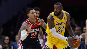 Apr 3, 2024; Washington, District of Columbia, USA; Los Angeles Lakers forward LeBron James (23) holds the ball as Washington Wizards forward Kyle Kuzma (33) defends at Capital One Arena. Mandatory Credit: Geoff Burke-Imagn Images