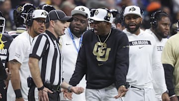 Dec 28, 2024; San Antonio, TX, USA; Colorado Buffaloes head coach Deion Sanders reacts with an official after a play during the second quarter against the Brigham Young Cougars at Alamodome. Mandatory Credit: Troy Taormina-Imagn Images