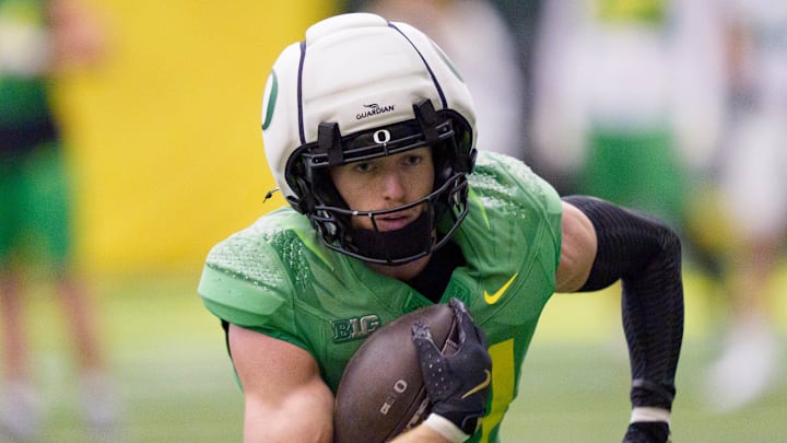 Oregon defensive back Dillon Thieneman carries the ball as the Oregon Ducks practice on Jan. 5, 2025, at the Moshofsky Center in Eugene, Oregon, ahead of the Peach Bowl.
