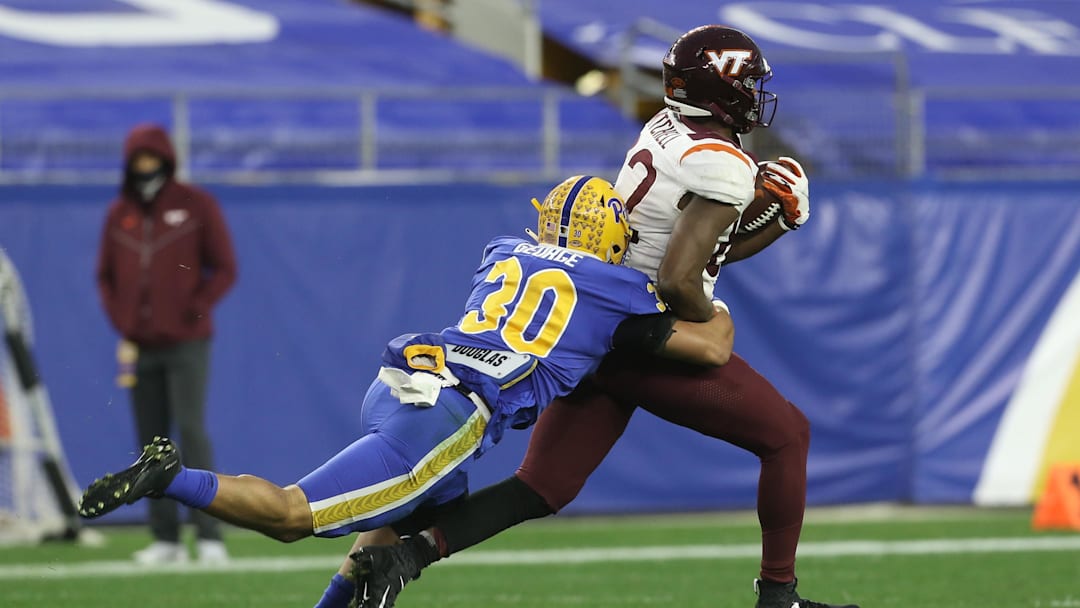 Nov 21, 2020; Pittsburgh, Pennsylvania, USA;  Virginia Tech Hokies tight end James Mitchell (82) runs after a catch as Pittsburgh Panthers linebacker Brandon George (30) tackles during the second quarter at Heinz Field. Mandatory Credit: Charles LeClaire-Imagn Images