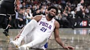 Apr 20, 2023; Brooklyn, New York, USA; Philadelphia 76ers center Joel Embiid (21) grimaces after falling to the floor during game three of the 2023 NBA playoffs against the Brooklyn Nets at Barclays Center. Mandatory Credit: Wendell Cruz-Imagn Images
