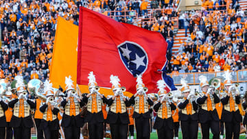 Nov 27, 2021; Knoxville, Tennessee, USA; Tennessee Volunteers take the field behind the Tennessee state flag as the band plays before a game against the Vanderbilt Commodores at Neyland Stadium. Mandatory Credit: Bryan Lynn-USA TODAY Sports