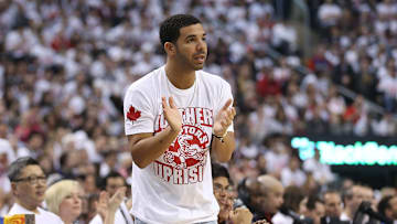Apr 19, 2014; Toronto, Ontario, CAN; Actor and rap artist Drake cheers on his team during the Toronto Raptors game against the Brooklyn Nets in game one during the first round of the 2014 NBA Playoffs at Air Canada Centre. The Nets beat the Raptors 94-87. Mandatory Credit: Tom Szczerbowski-Imagn Images