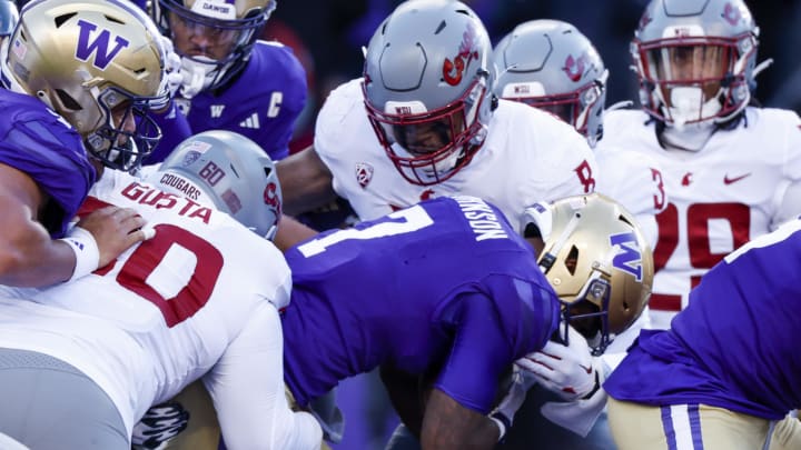 Nov 25, 2023; Seattle, Washington, USA; Washington Huskies running back Dillon Johnson (7) rushes for a touchdown against Washington State Cougars linebacker Devin Richardson (8) during the first quarter at Alaska Airlines Field at Husky Stadium. Mandatory Credit: Joe Nicholson-USA TODAY Sports