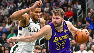 Los Angeles Lakers guard Luka Doncic (77) drives to the basket against Milwaukee Bucks forward Giannis Antetokounmpo (34) in the third quarter at Fiserv Forum.