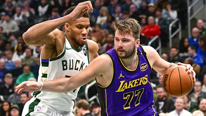 Los Angeles Lakers guard Luka Doncic (77) drives to the basket against Milwaukee Bucks forward Giannis Antetokounmpo (34) in the third quarter at Fiserv Forum.