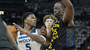 Minnesota Timberwolves guard Anthony Edwards controls the ball against Golden State Warriors forward Draymond Green in the first quarter during Game 1 of a Western Conference semifinal at Target Center in Minneapolis on May 6, 2025. 