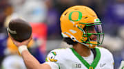 Nov 29, 2025; Seattle, Washington, USA; Oregon Ducks quarterback Dante Moore (5) passes the ball against the Washington Huskies during the first half at Husky Stadium. Mandatory Credit: Steven Bisig-Imagn Images