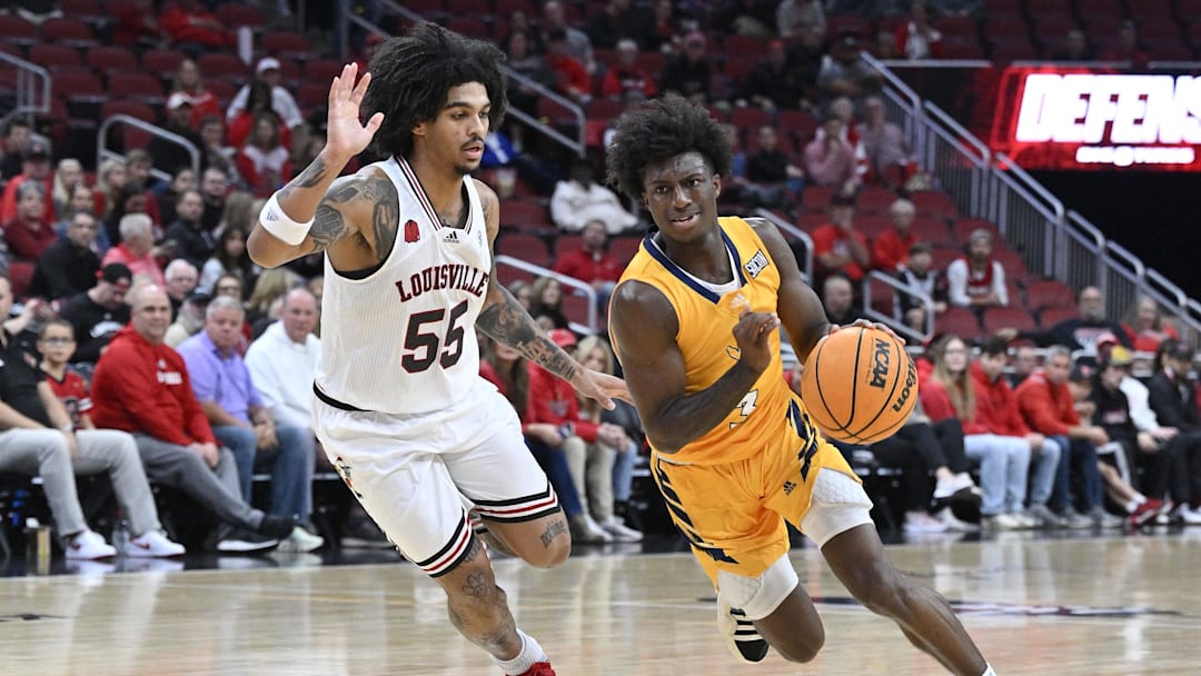 Nov 10, 2023; Louisville, Kentucky, USA; Chattanooga Mocs guard Honor Huff (3) dribbles against Louisville Cardinals guard Skyy Clark (55) during the first half at KFC Yum! Center. Mandatory Credit: Jamie Rhodes-Imagn Images Nov 10, 2023; Louisville, Kentucky, USA; Chattanooga Mocs guard Honor Huff (3) dribbles against Louisville Cardinals guard Skyy Clark (55) during the first half at KFC Yum! Center. Mandatory Credit: Jamie Rhodes-Imagn Images