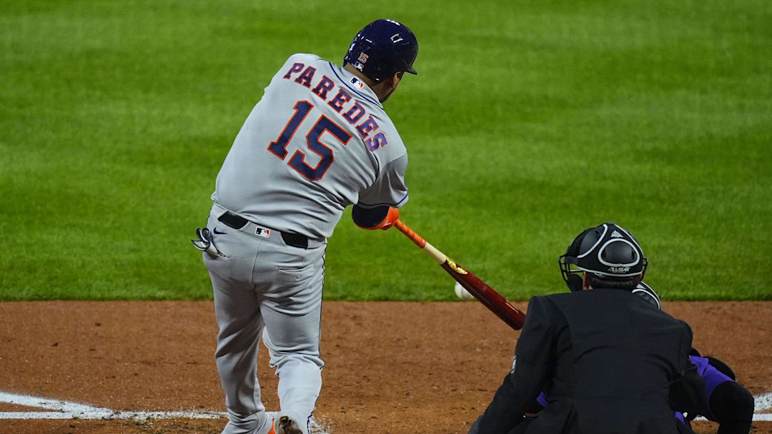 Apr 7, 2026; Denver, Colorado, USA; Houston Astros third baseman Isaac Paredes (15) singles in the fourth inning against the Colorado Rockies at Coors Field. Mandatory Credit: Ron Chenoy-Imagn Images