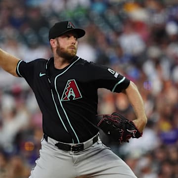 Jun 21, 2025; Denver, Colorado, USA; Arizona Diamondbacks starting pitcher Merrill Kelly (29) delivers a pitch in the fourth inning against the Colorado Rockies at Coors Field. Mandatory Credit: Ron Chenoy-Imagn Images