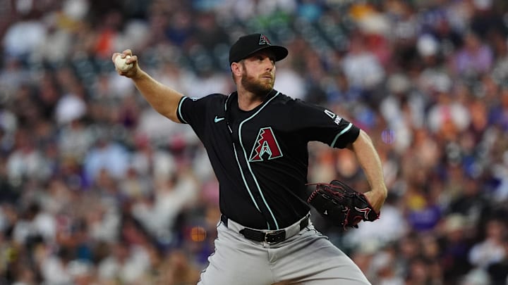 Jun 21, 2025; Denver, Colorado, USA; Arizona Diamondbacks starting pitcher Merrill Kelly (29) delivers a pitch in the fourth inning against the Colorado Rockies at Coors Field. Mandatory Credit: Ron Chenoy-Imagn Images