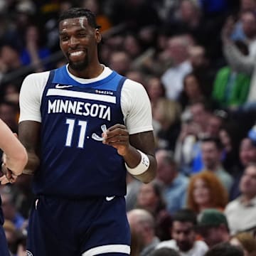 Mar 12, 2025; Denver, Colorado, USA; Minnesota Timberwolves center Naz Reid (11) celebrates his three point score with guard Donte DiVincenzo (0) in the second half against the Denver Nuggets at Ball Arena.
