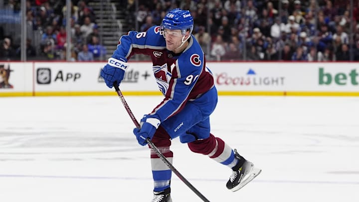 Jan 14, 2025; Denver, Colorado, USA; Colorado Avalanche right wing Mikko Rantanen (96) shoots the puck in the second period against the New York Rangers at Ball Arena. Mandatory Credit: Ron Chenoy-Imagn Images