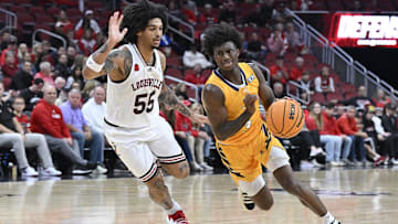 Nov 10, 2023; Louisville, Kentucky, USA; Chattanooga Mocs guard Honor Huff (3) dribbles against Louisville Cardinals guard Skyy Clark (55) during the first half at KFC Yum! Center. Mandatory Credit: Jamie Rhodes-Imagn Images