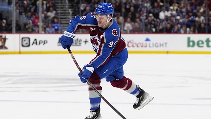 Jan 14, 2025; Denver, Colorado, USA; Colorado Avalanche right wing Mikko Rantanen (96) shoots the puck in the second period against the New York Rangers at Ball Arena. Mandatory Credit: Ron Chenoy-Imagn Images
