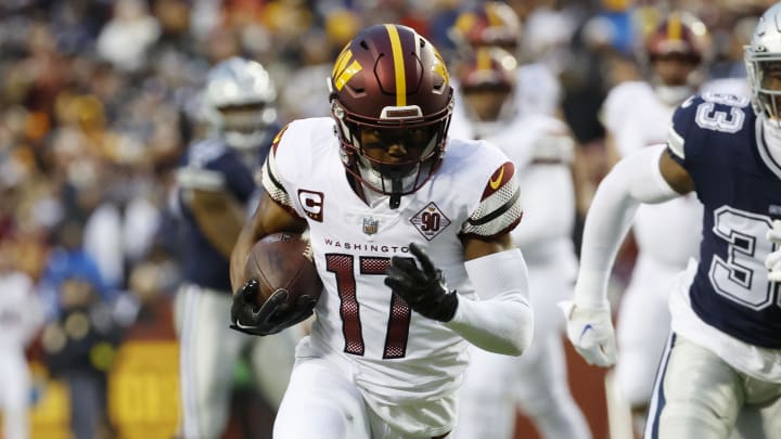 Jan 8, 2023; Landover, Maryland, USA; Washington Commanders wide receiver Terry McLaurin (17) runs with the ball for a touchdown as Dallas Cowboys linebacker Damone Clark (33) chases during the first quarter at FedExField. Mandatory Credit: Geoff Burke-USA TODAY Sports