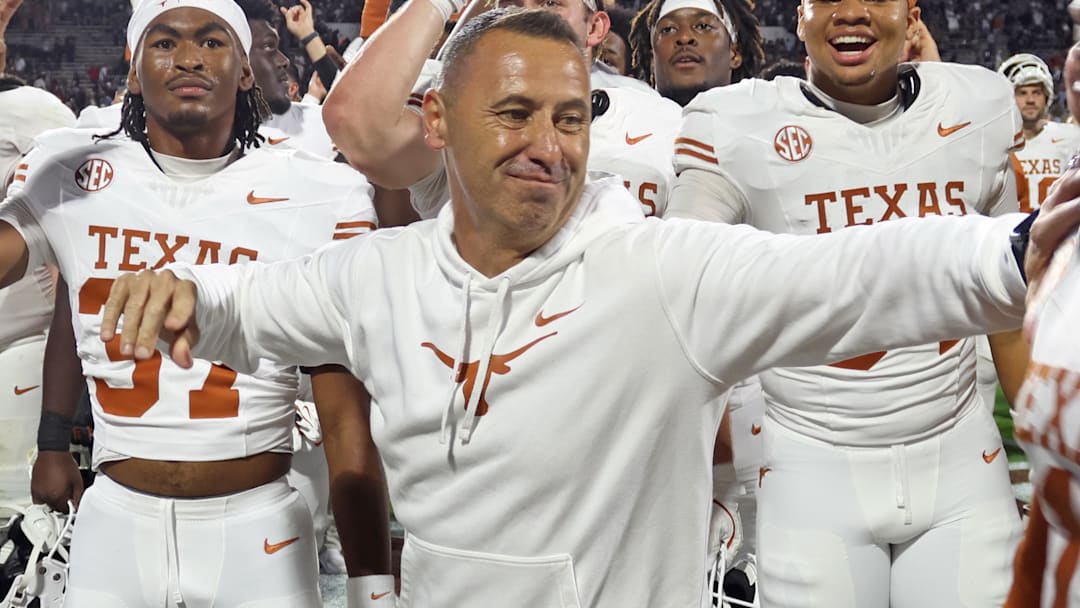 Texas Longhorns head coach Steve Sarkisian reacts with defensive linemen Colin Simmons (1) after beating the Mississippi State Bulldogs in overtime at Davis Wade Stadium at Scott Field.