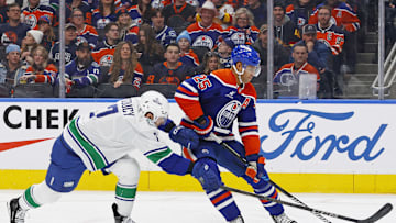 Edmonton Oilers defensemen Darnell Nurse (25) protects the puck from Vancouver Canucks defensemen Carson Soucy (7)