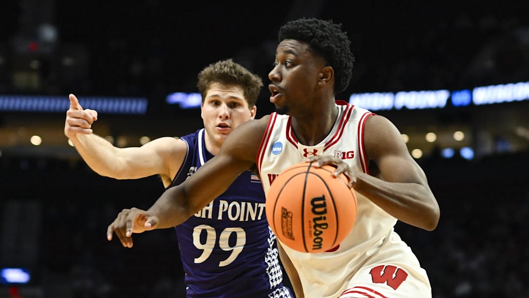 Mar 19, 2026; Portland, OR, USA; Wisconsin Badgers guard John Blackwell (25) drives to the basket against High Point Panthers guard Chase Johnston (99) during the second half of a first round game of the men's 2026 NCAA Tournament at Moda Center. Mandatory Credit: Troy Wayrynen-Imagn Images