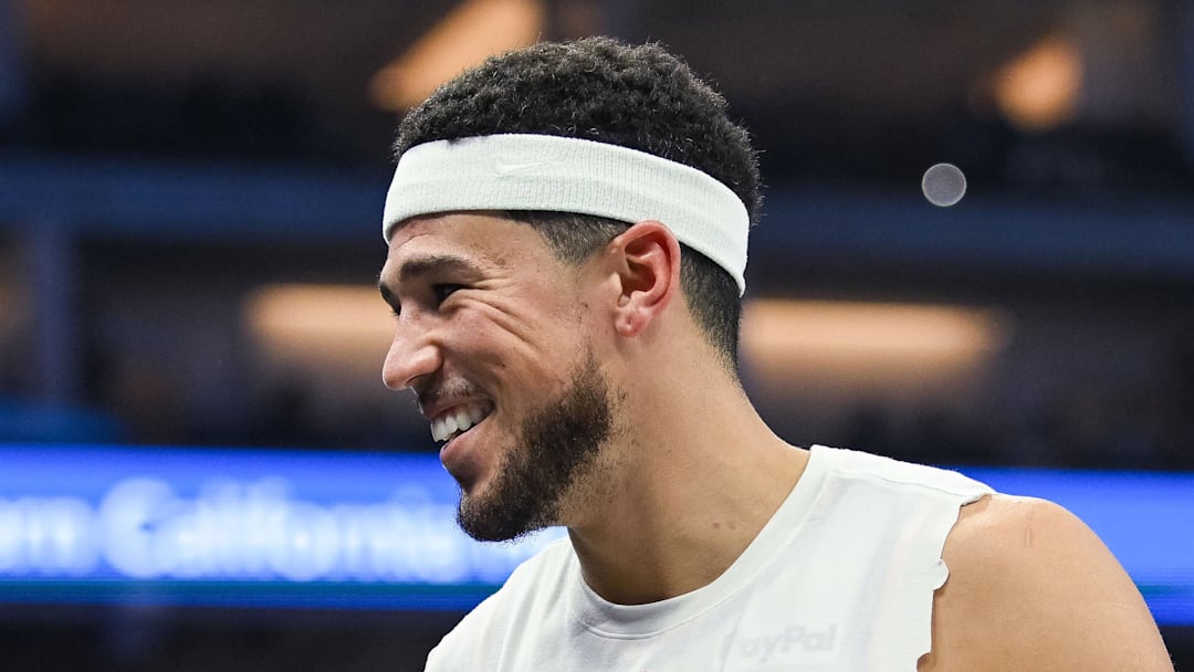 Nov 26, 2025; Sacramento, California, USA; Phoenix Suns guard Devin Booker (1) smiles on the sideline during the second quarter of the game against the Sacramento Kings at Golden 1 Center. Mandatory Credit: Ed Szczepanski-Imagn Images