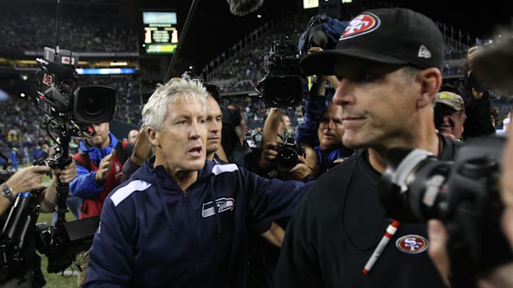  Head Coach Jim Harbaugh of the San Francisco 49ers shakes hands with Head Coach Pete Carroll of the Seattle Seahawks on the field following the game at CenturyLink Field on September 15, 2013 in Seattle, Washington. The Seahawks defeated the 49ers 29-3. 