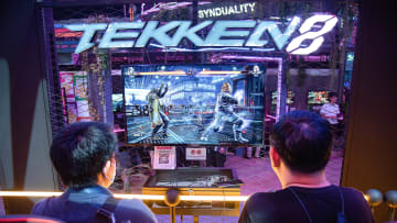 Visitors seen playing a "Tekken 8" video game on computer...
