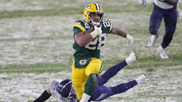Green Bay Packers running back A.J. Dillon (28) breaks away from Tennessee Titans strong safety Kenny Vaccaro (24) for a touchdown run in the third quarter during their football game on December 27, 2020, at Lambeau Field in Green Bay, Wis.