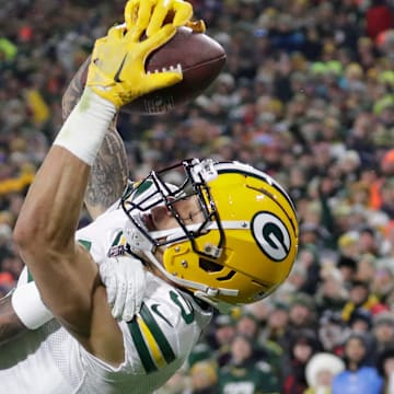 Green Bay Packers wide receiver Christian Watson (9) scores a touchdown against Tennessee Titans cornerback Kristian Fulton in 2022.