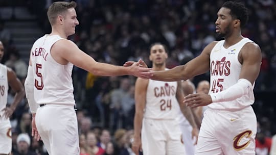 Feb 12, 2025; Toronto, Ontario, CAN; Cleveland Cavaliers guard Sam Merrill (5) and guard Donovan Mitchell (45) celebrate a basket against the Toronto Raptors at Scotiabank Arena. Mandatory Credit: John E. Sokolowski-Imagn Images